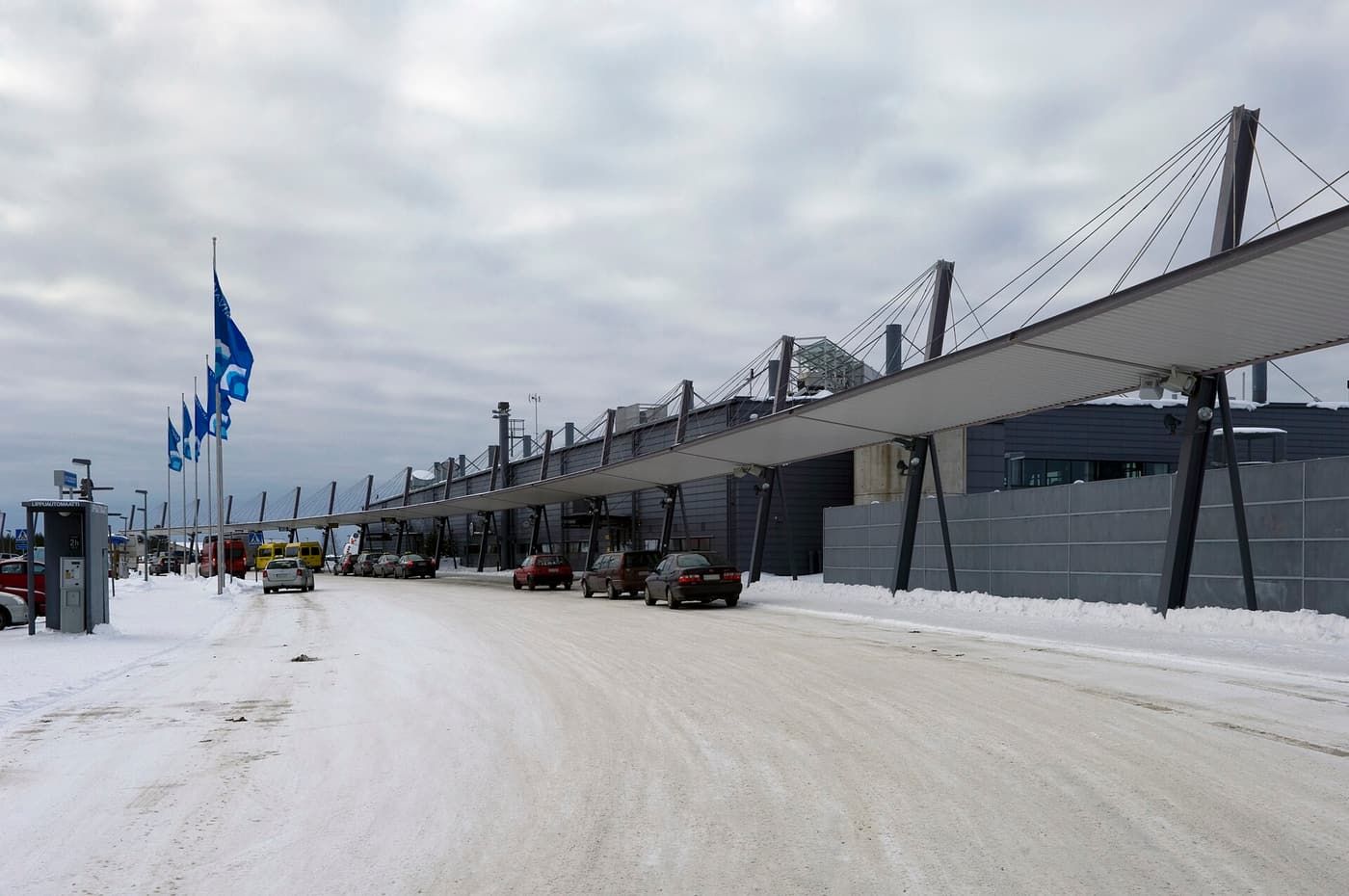 The terminal of Rovaniemi Airport under snow on a clear winter day