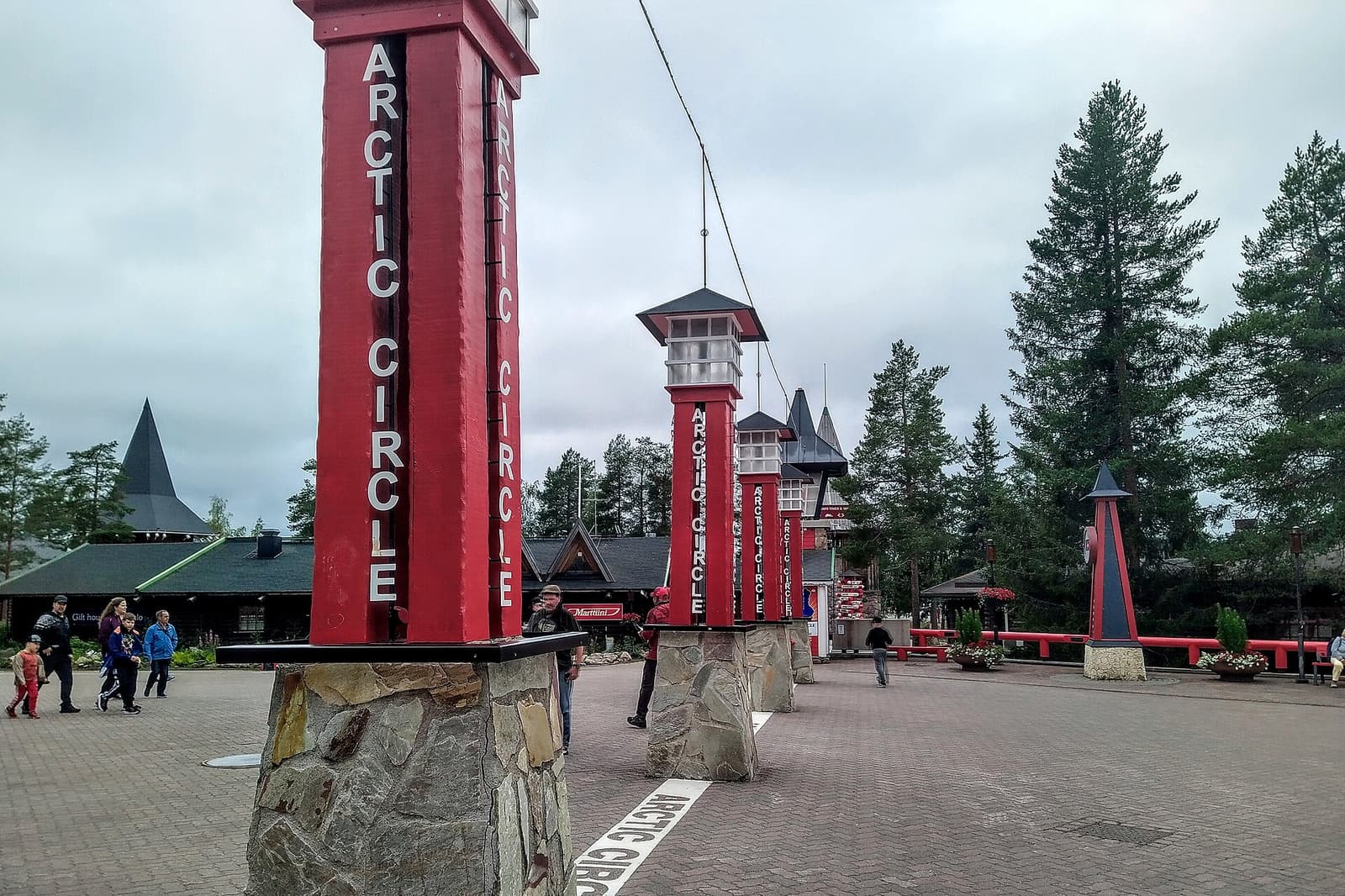 Red pillars marking the Arctic Circle line in the square of Santa Claus Village