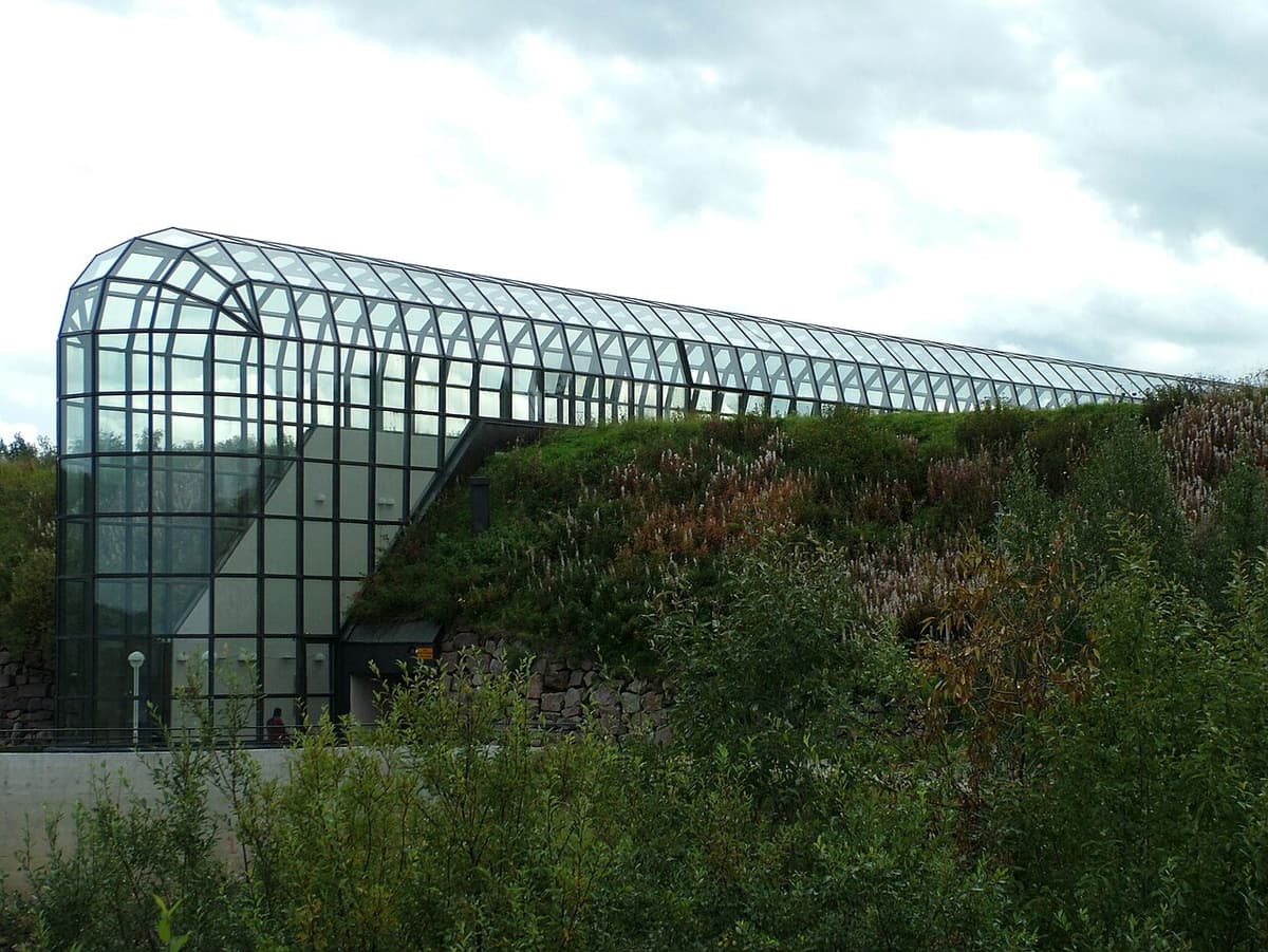 The glass vault of Arktikum rising above its grass-covered roof